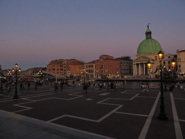 a large city square with a green dome and a crosswalk